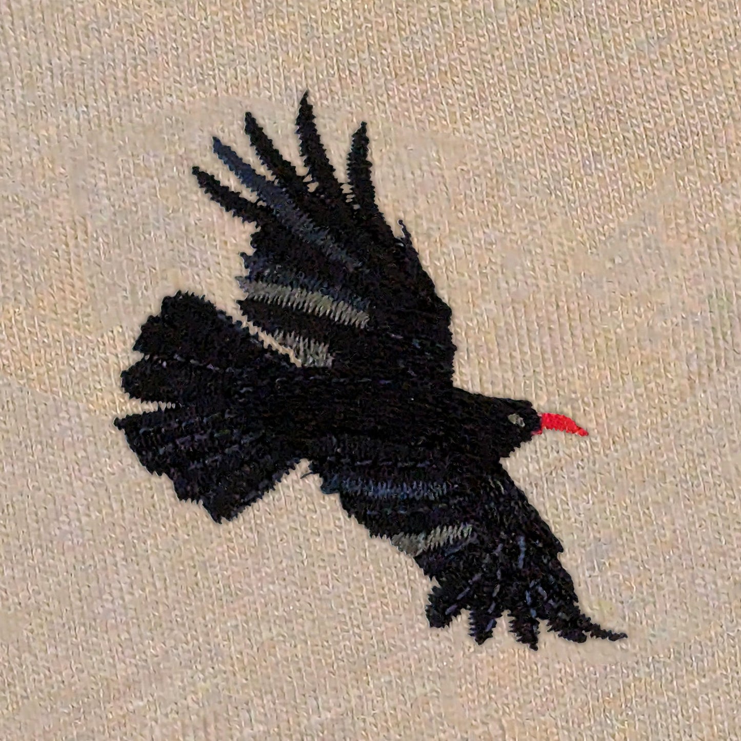 Closeup photo of the Chough embroidery design